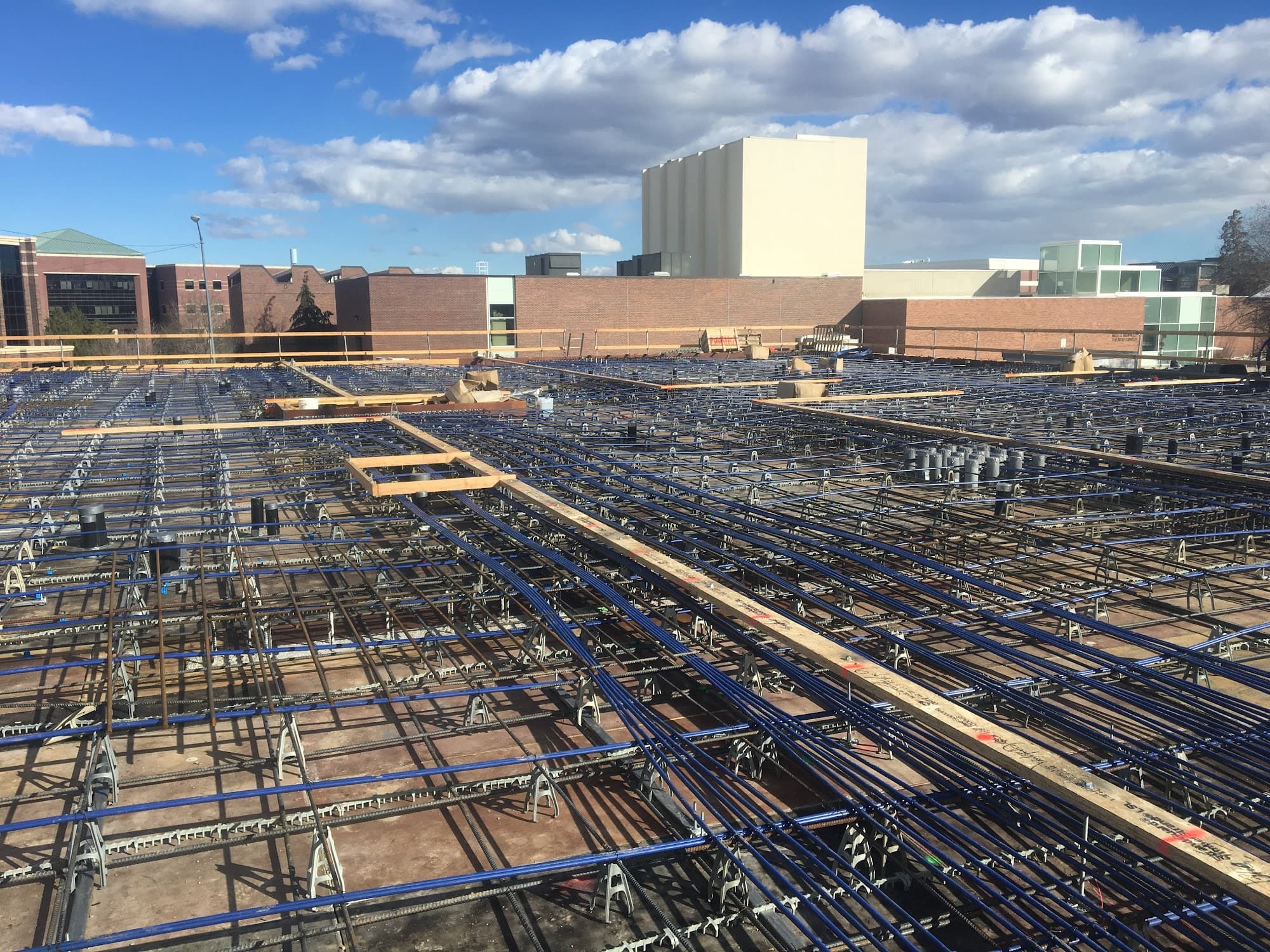 Expansive commercial foundation rebar grid with conduit — structural value engineering optimization