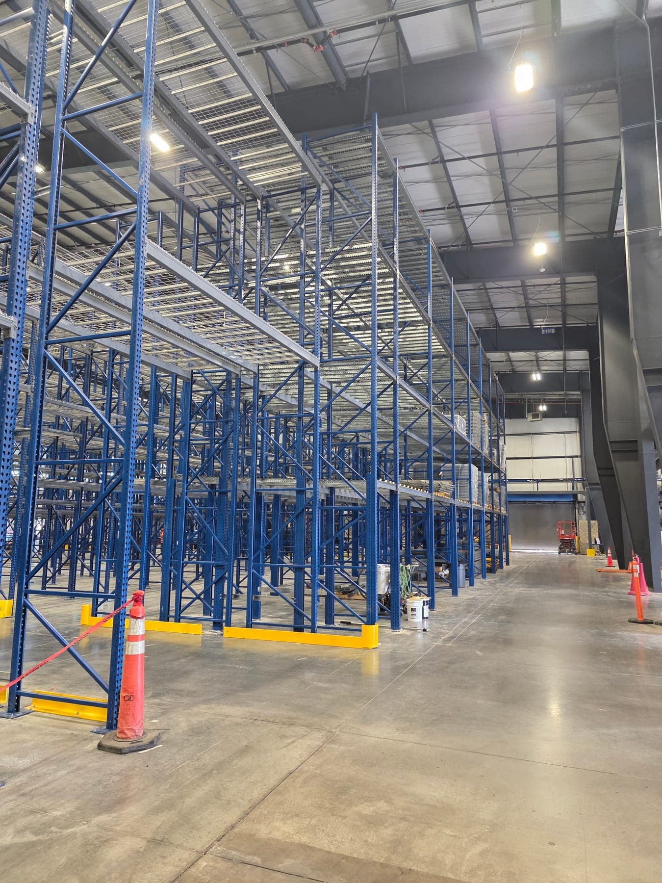 High-bay pallet racking with wire decking standing on a finished concrete warehouse slab