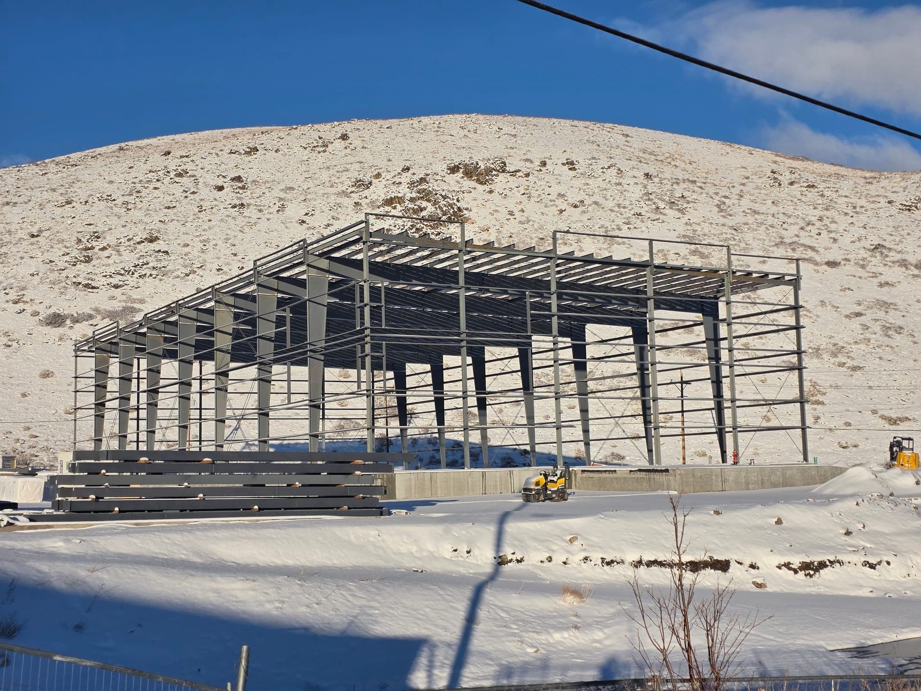 Pre-engineered metal building frames with girts and purlins erected on a finished foundation