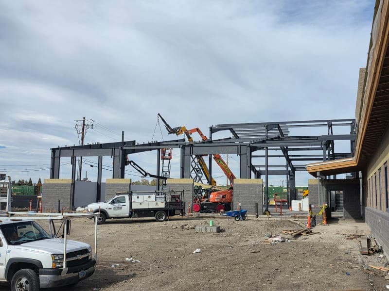 Getto Transportation Center during construction — steel frame with masonry walls and heavy equipment